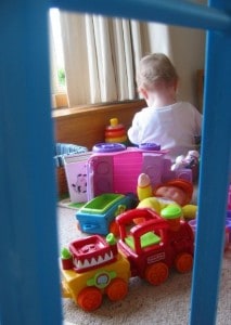 baby girl playing among toys