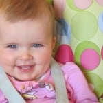 baby smiling in high chair