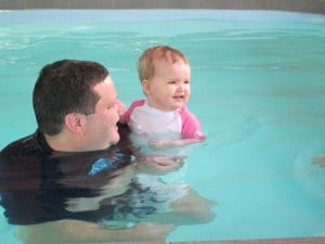 dad and baby swimming