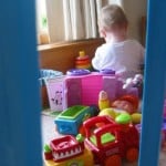 baby girl playing among toys