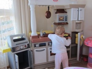Girl in children's kitchen