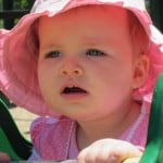 baby in pink hat
