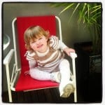 child in red chair
